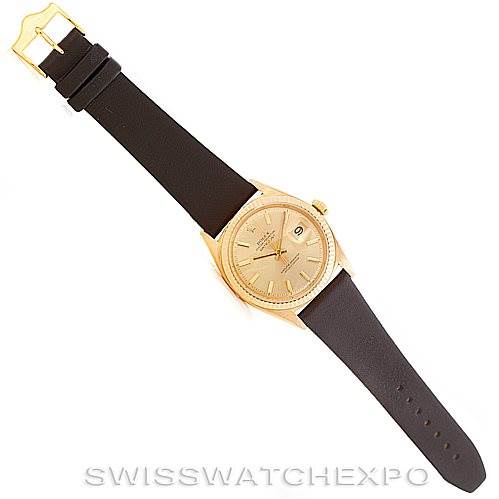 This image shows a President model Rolex watch from a top-down angle, highlighting the watch face, leather strap, and clasp.