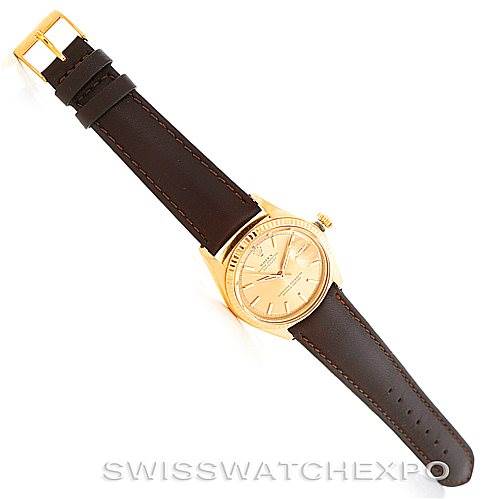 The image shows a Rolex President 1601 Men
s Yellow Gold Champagne Dial 1601 Men
s Yellow Gold Champagne Dial model watch, with a front view displaying its face and leather strap fully extended.