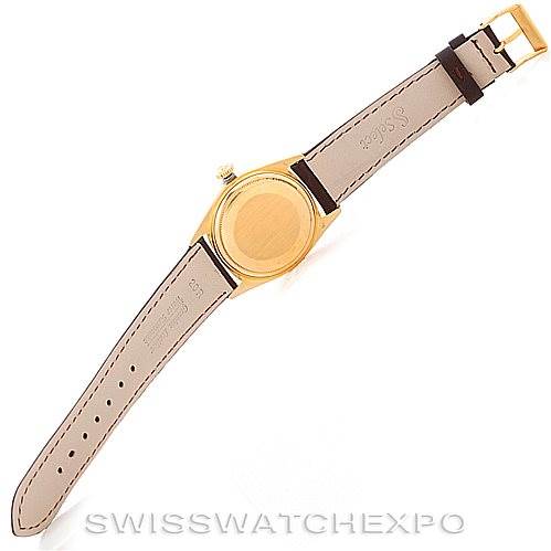 The image shows the back and strap of a Rolex President 1601 Men
s Yellow Gold Champagne Dial 1601 Men
s Yellow Gold Champagne Dial model watch from a top-down angle.