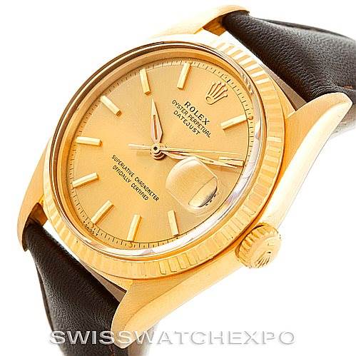 This image shows a Rolex President 1601 Men
s Yellow Gold Champagne Dial 1601 Men
s Yellow Gold Champagne Dial model watch at an angled view, displaying the dial, crown, and part of the leather strap.