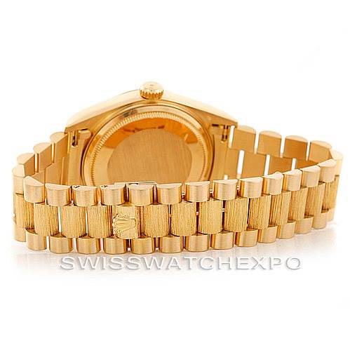 The image shows the back of a Rolex President 18078 Men
s Yellow Gold Champagne Dial 18078 Men
s Yellow Gold Champagne Dial model watch, highlighting the case back and the gold presidential bracelet.