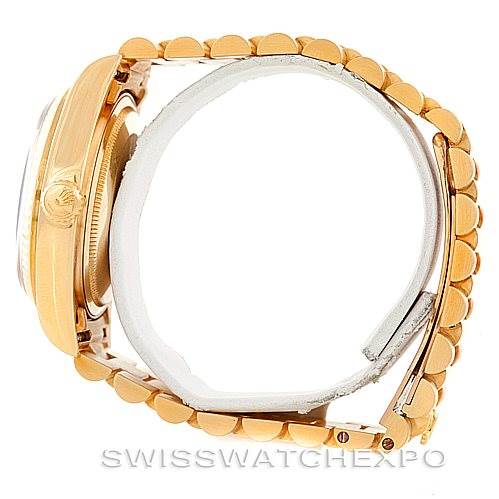 This side view of the Rolex President 18038 Men's Yellow Gold Brown Dial 18038 Men's Yellow Gold Brown Dial watch shows the case, crown, and part of the President bracelet.