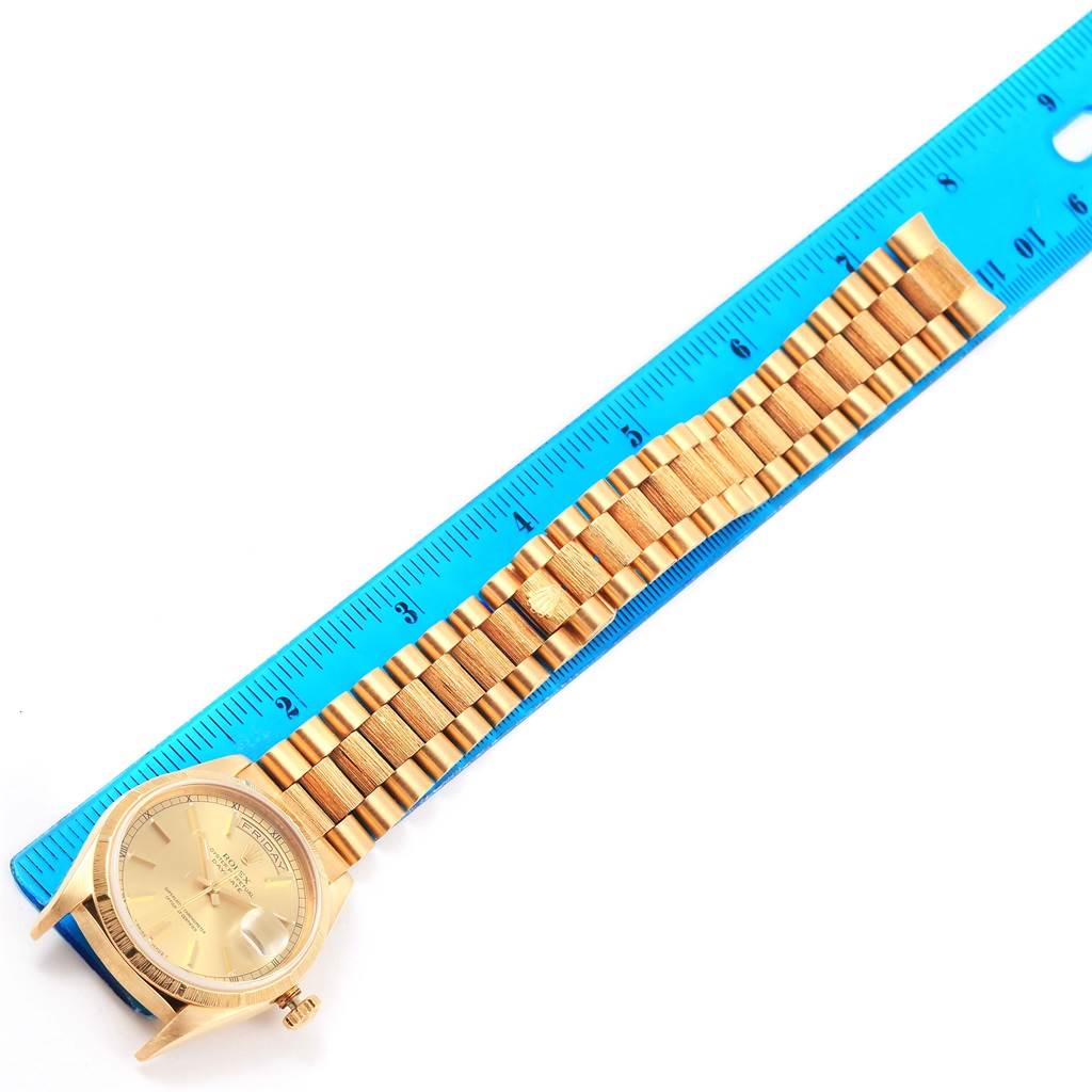 This image shows a Rolex President 18248 Men's Yellow Gold Champagne Dial 18248 Men's Yellow Gold Champagne Dial model watch laid flat beside a ruler, displaying its full band and face.