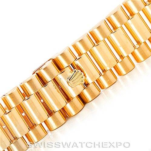 The image shows a close-up of the gold bracelet of a Rolex President 18038 Men's Yellow Gold Black Dial 18038 Men's Yellow Gold Black Dial model, featuring the clasp with the Rolex crown logo.