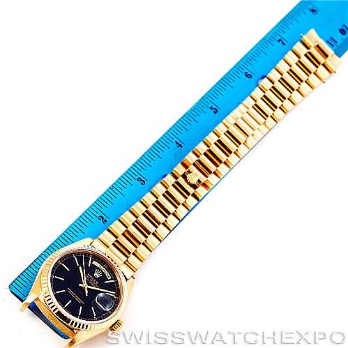 The image shows the entire President model Rolex watch, laid flat next to a blue ruler for measurement.