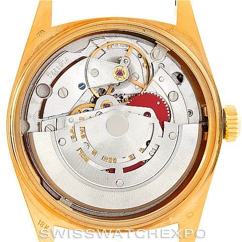 The image showcases the inner mechanism and movement of a Rolex President 18038 Men's Yellow Gold Black Dial 18038 Men's Yellow Gold Black Dial model watch from a back angle with the case back removed.