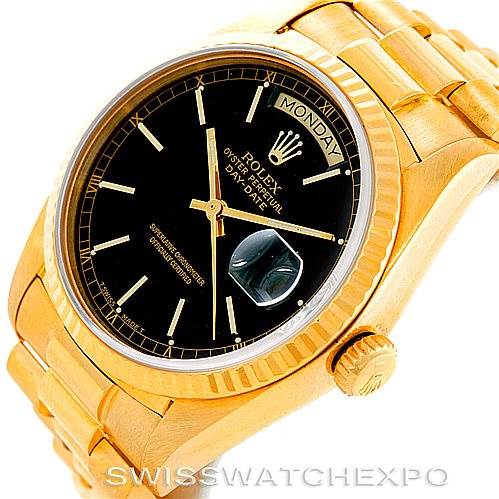The image showcases a Rolex President 18038 Men's Yellow Gold Black Dial 18038 Men's Yellow Gold Black Dial model watch at an angle displaying its gold case, black dial, day-date window, and part of the bracelet.