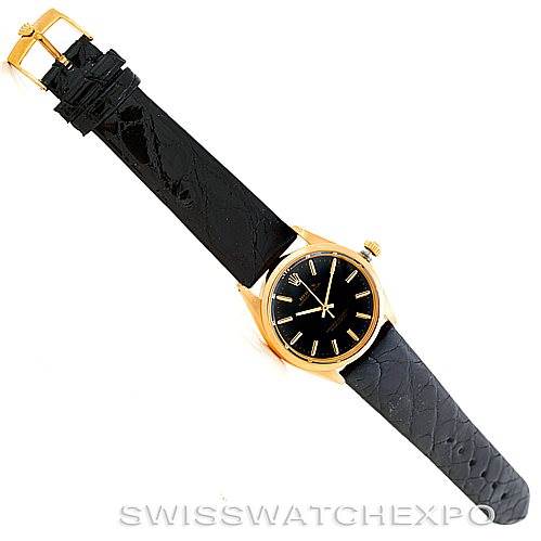The image shows an aerial view of a Rolex President 1002 Men's Steel and Gold (two tone) Black Dial 1002 Men's Steel and Gold (two tone) Black Dial model watch with a black leather strap and gold casing.