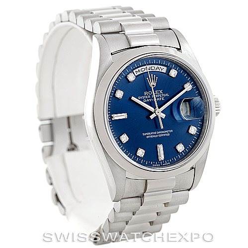 The image shows a Rolex President 18206 Men's Platinum Blue Dial 18206 Men's Platinum Blue Dial model watch at a front angle, highlighting its blue dial, diamond hour markers, and metal bracelet.
