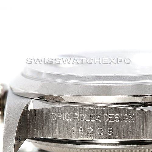 This close-up image of a Rolex President 18206 Men's Platinum Blue Dial 18206 Men's Platinum Blue Dial model focuses on the side of the case, showing the etching "ORIG ROLEX DESIGN 18206".