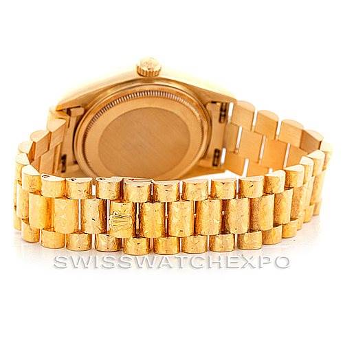 The image shows the back and bracelet of a Rolex President 18038 Men
s Yellow Gold Silver Dial 18038 Men
s Yellow Gold Silver Dial model watch, highlighting its gold links and clasp.