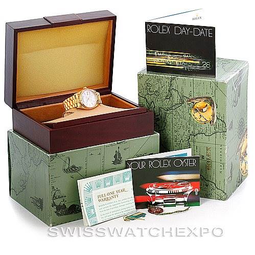 This image shows a Rolex President 18038 Men
s Yellow Gold Silver Dial 18038 Men
s Yellow Gold Silver Dial model watch angled slightly from above, with its box, warranty card, and booklets.