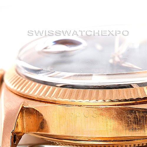 The image shows a close-up, side angle view of a Rolex President 1803 Men
s Rose Gold Black Dial 1803 Men
s Rose Gold Black Dial watch, highlighting the bezel and part of the bracelet link.