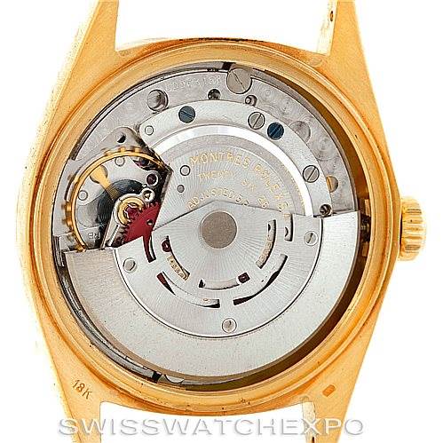 The image shows the internal mechanism of a Rolex President 1803 Men
s Yellow Gold Champagne Dial 1803 Men
s Yellow Gold Champagne Dial watch from the rear, exposing its intricate components.