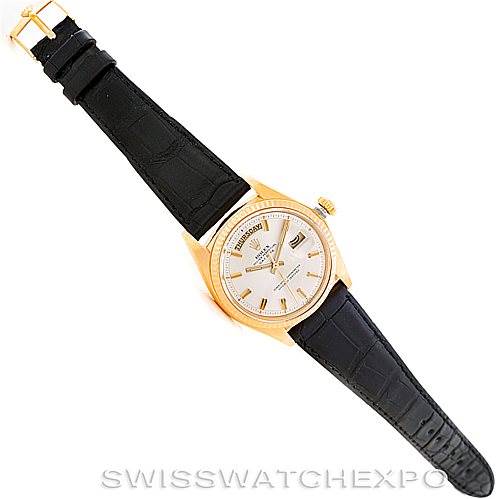 The Rolex President 1803 Men
s Yellow Gold Silver Dial 1803 Men
s Yellow Gold Silver Dial model watch is shown from a top-down angle, displaying the entire face, bezel, and black leather strap.