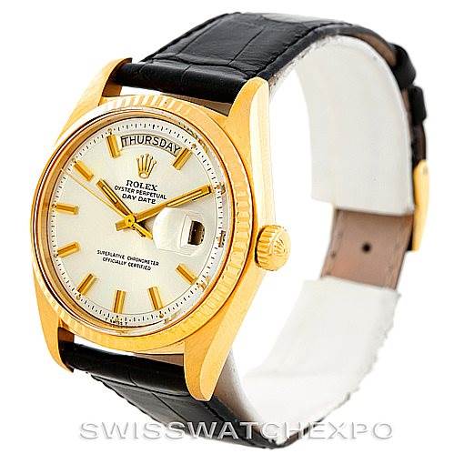 The image shows a Rolex President 1803 Men
s Yellow Gold Silver Dial 1803 Men
s Yellow Gold Silver Dial model watch from an angle that displays its face, gold bezel, crown, and leather strap.