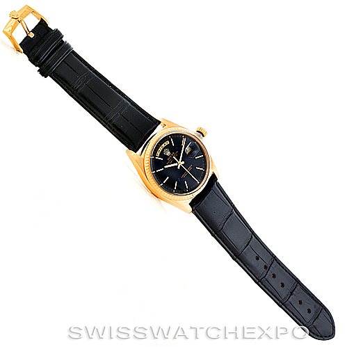 The Rolex President 1803 Men's Yellow Gold Black Dial 1803 Men's Yellow Gold Black Dial model watch is shown from a top-down angle, displaying its black leather strap and gold case with a black dial.