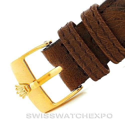 This image shows a close-up of the gold buckle and brown leather strap of a Rolex President 1803 Men
s Yellow Gold Champagne Dial 1803 Men
s Yellow Gold Champagne Dial model watch.