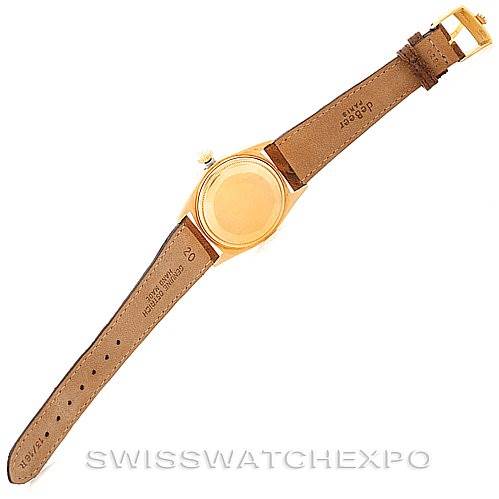 The image shows the back view of the Rolex President 1803 Men
s Yellow Gold Champagne Dial 1803 Men
s Yellow Gold Champagne Dial model watch, displaying its case back and leather strap.