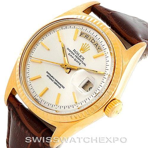 This image shows a Rolex President 1803 Men
s Yellow Gold Silver Dial 1803 Men
s Yellow Gold Silver Dial model watch at a three-quarter angle displaying the face, crown, and part of the leather strap.