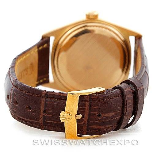 The image shows the back of a Rolex President 1803 Men
s Yellow Gold Silver Dial 1803 Men
s Yellow Gold Silver Dial model watch, focusing on the clasp and leather strap.