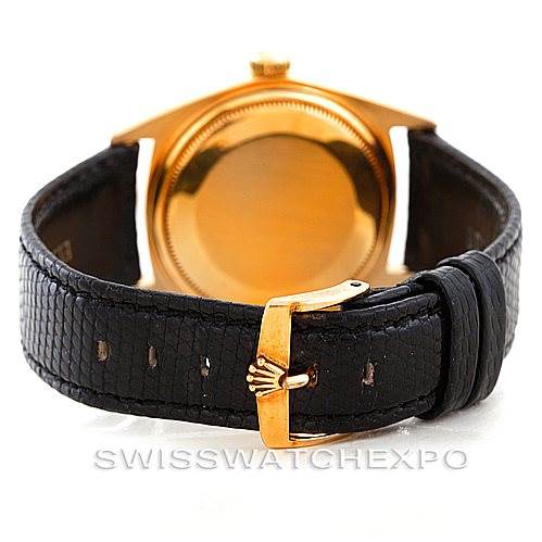 This image shows a rear view of the Rolex President 1803 Men
s Yellow Gold Silver Dial 1803 Men
s Yellow Gold Silver Dial watch, highlighting its gold caseback and black leather strap with a gold buckle.