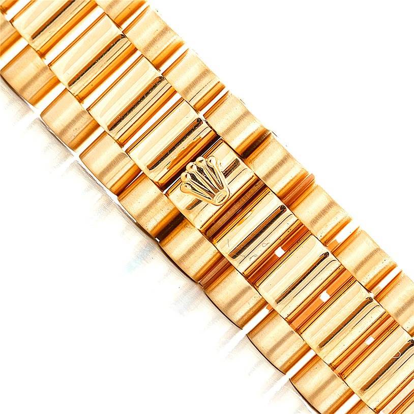 This close-up image shows the gold bracelet of a Rolex President 18238 Men
s Yellow Gold Champagne Dial 18238 Men
s Yellow Gold Champagne Dial model watch, featuring the signature Rolex crown emblem.