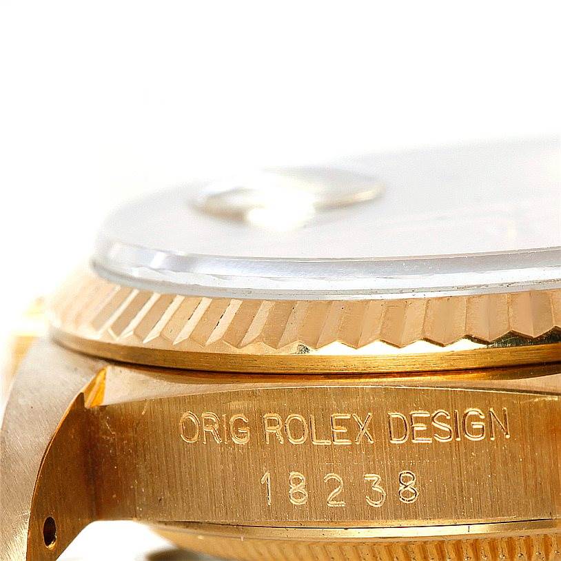 This image shows a close-up angle of a Rolex President 18238 Men
s Yellow Gold Champagne Dial 18238 Men
s Yellow Gold Champagne Dial model, focusing on the bezel, casing, and model number engraving.