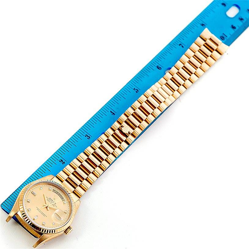 The Rolex President 18238 Men
s Yellow Gold Champagne Dial 18238 Men
s Yellow Gold Champagne Dial model watch is shown from above, displaying the face, bracelet, and a ruler for measurement.