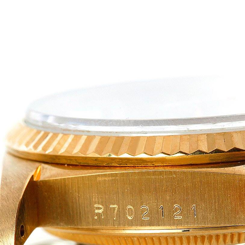 The image shows a close-up side view of the case bezel and serial number of a Rolex President 18238 Men
s Yellow Gold Champagne Dial 18238 Men
s Yellow Gold Champagne Dial model watch.