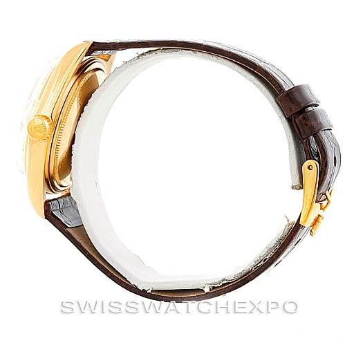 The Rolex President 1807 Men
s Yellow Gold Silver Dial 1807 Men
s Yellow Gold Silver Dial watch model is shown from a side angle, focusing on the case and brown leather strap with a gold buckle.