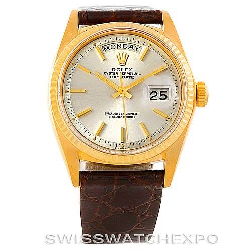The image shows a front view of a Rolex President 1807 Men
s Yellow Gold Silver Dial 1807 Men
s Yellow Gold Silver Dial model watch with a gold case, day and date display, and brown leather strap.