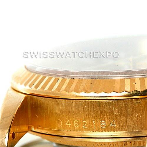 This image shows a side angle of the Rolex President 118238 Men's Yellow Gold Champagne Dial 118238 Men's Yellow Gold Champagne Dial model watch, focusing on the bezel, crystal, and part of the case with visible serial number.