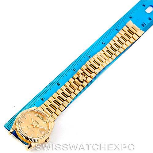 This image shows a top-down view of the Rolex President 118238 Men's Yellow Gold Champagne Dial 118238 Men's Yellow Gold Champagne Dial model watch alongside a ruler for scale.