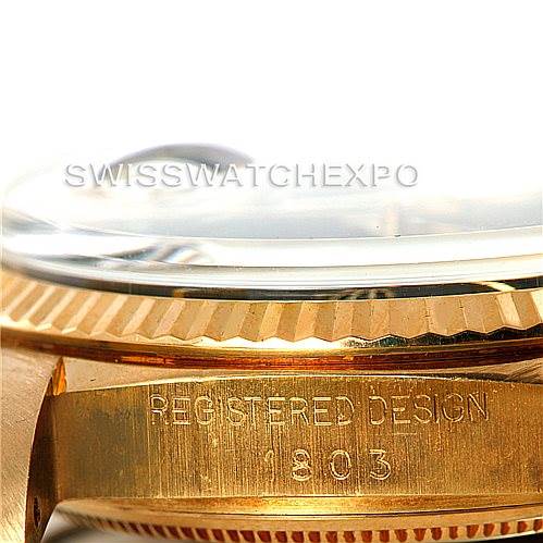 The image shows a close-up of the side of a Rolex President 1803 Men's Yellow Gold Black Dial 1803 Men's Yellow Gold Black Dial model, focusing on the bezel and the "REGISTERED DESIGN" engraving.