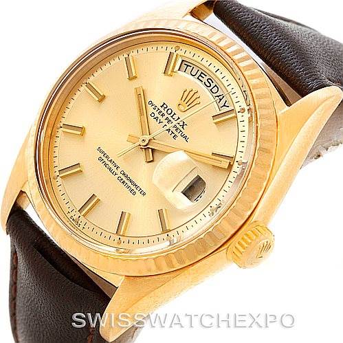 The image shows a Rolex President 1803 Men
s Yellow Gold Champagne Dial 1803 Men
s Yellow Gold Champagne Dial watch at an angle highlighting the dial, crown, leather strap, and day/date indicators.