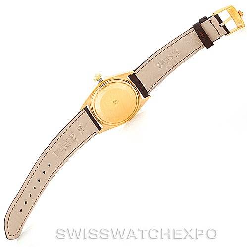 This image shows the backside of a Rolex President 1803 Men
s Yellow Gold Champagne Dial 1803 Men
s Yellow Gold Champagne Dial model watch, highlighting the case and leather straps.