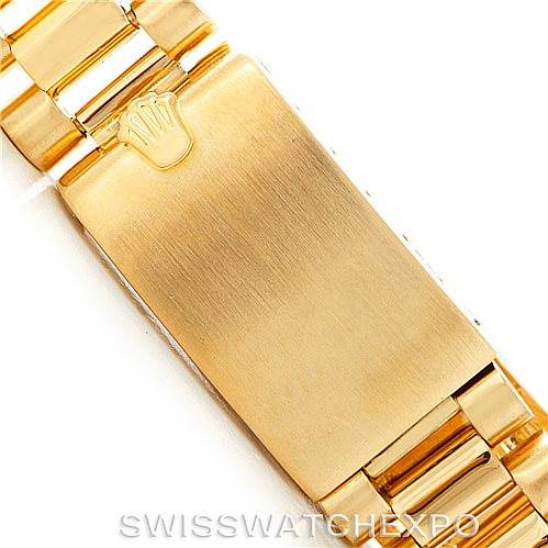 This image shows a close-up of the clasp and part of the bracelet of the gold Rolex President 1803 Men
s Yellow Gold Champagne Dial 1803 Men
s Yellow Gold Champagne Dial model.