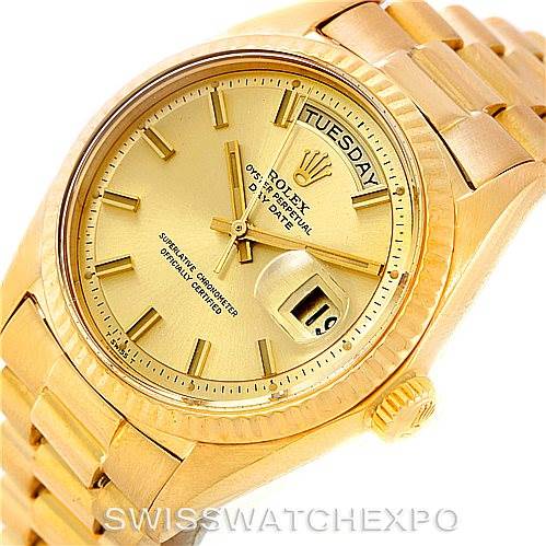 This image shows a close-up of the Rolex President 1803 Men
s Yellow Gold Champagne Dial 1803 Men
s Yellow Gold Champagne Dial model watch featuring its dial, day display, date window, and part of the bracelet.