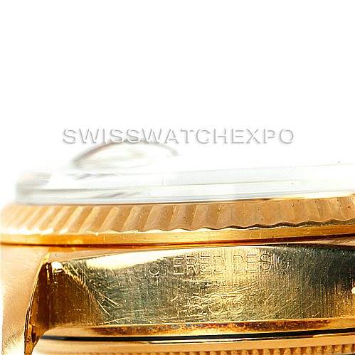 The image shows a close-up at an angle of the Rolex President 1803 Men
s Yellow Gold Champagne Dial 1803 Men
s Yellow Gold Champagne Dial watch
s gold case and fluted bezel, emphasizing the engraved details.