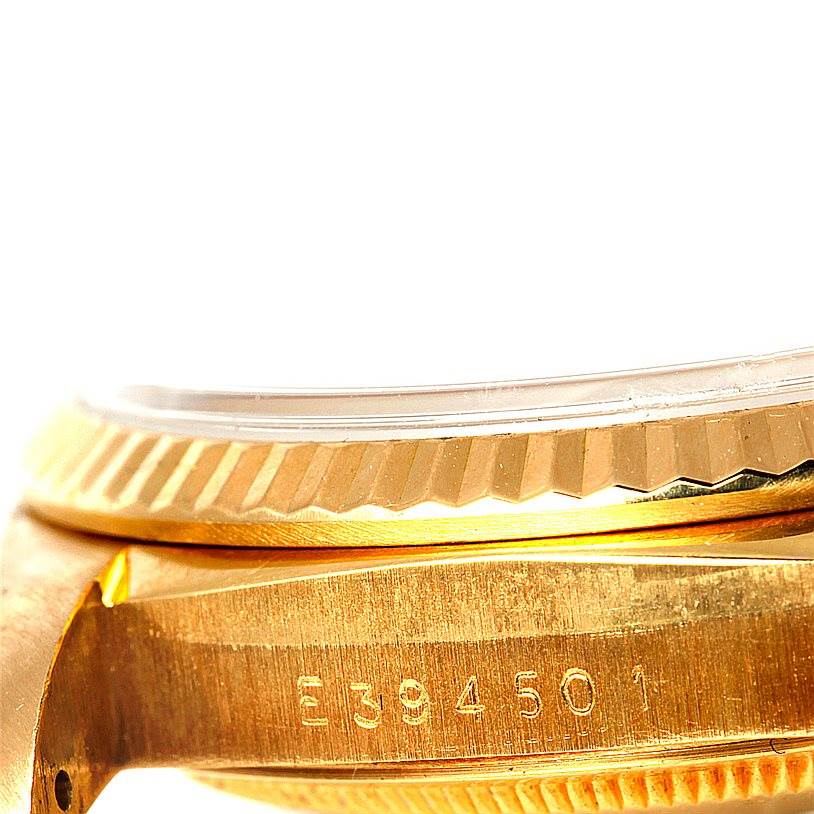 The image shows a close-up angle of the Rolex President 18238 Men
s Yellow Gold Champagne Dial 18238 Men
s Yellow Gold Champagne Dial model, focusing on the case, fluted bezel, and serial number.