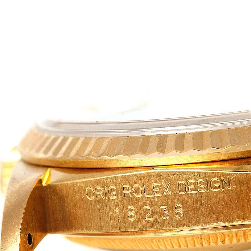 This image shows a close-up side view of a Rolex President 18238 Men
s Yellow Gold Champagne Dial 18238 Men
s Yellow Gold Champagne Dial model watch, highlighting the case edge and bezel along with the serial number.