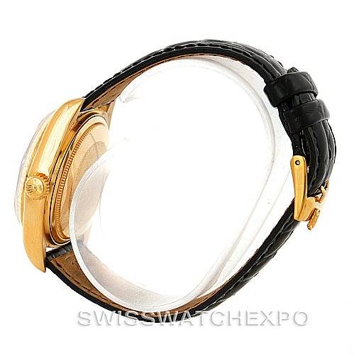 The image shows a side view of a Rolex President 18038 Men
s Yellow Gold Champagne Dial 18038 Men
s Yellow Gold Champagne Dial watch, focusing on the gold case, crown, and black leather strap with a clasp.