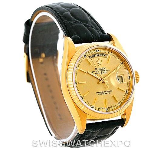 The Rolex President 18038 Men
s Yellow Gold Champagne Dial 18038 Men
s Yellow Gold Champagne Dial model watch is shown at an oblique angle, highlighting its gold case, dial, and black leather strap.