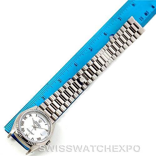 The Rolex President 18239 Men's White Gold White Dial 18239 Men's White Gold White Dial model watch is shown from a top-down angle, displaying its face, case, and metal bracelet alongside a ruler for scale.