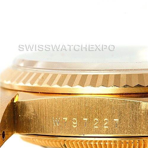 The image shows a side angle of the case and bezel of a Rolex President 18238 Men
s Yellow Gold Champagne Dial 18238 Men
s Yellow Gold Champagne Dial model watch, featuring a serial number engraving.