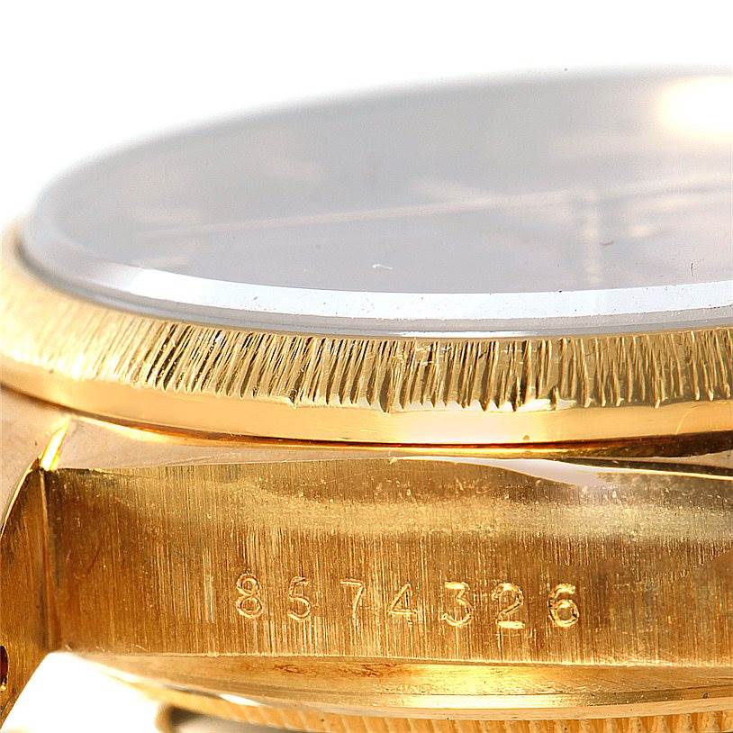 The image shows a close-up, angled view of the bezel and case side with a serial number of a Rolex President 18038 Men
s Yellow Gold Brown Dial 18038 Men
s Yellow Gold Brown Dial model watch.