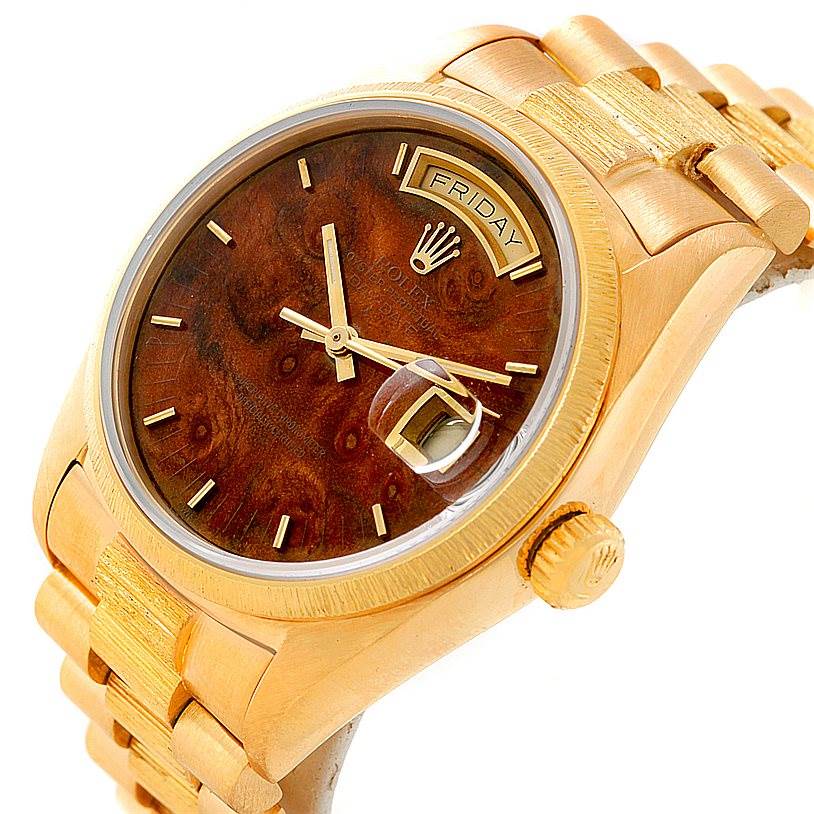 The image shows a Rolex President 18038 Men
s Yellow Gold Brown Dial 18038 Men
s Yellow Gold Brown Dial model watch from an angle highlighting the face, day display, crown, and part of the bracelet.