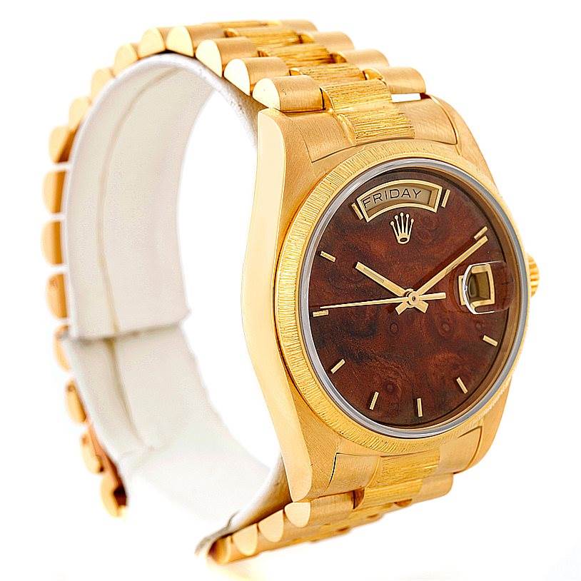 The image shows a Rolex President 18038 Men
s Yellow Gold Brown Dial 18038 Men
s Yellow Gold Brown Dial model watch from a front-left angle, highlighting its band, dial, and day-date display.