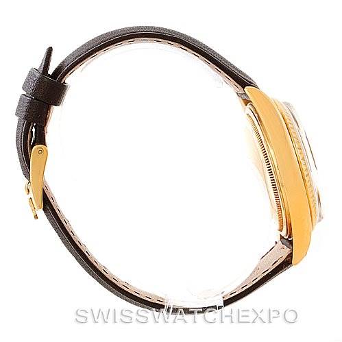 The image shows a side view of a Rolex President 1803 Men
s Yellow Gold Champagne Dial 1803 Men
s Yellow Gold Champagne Dial model watch with a leather strap and a gold case.